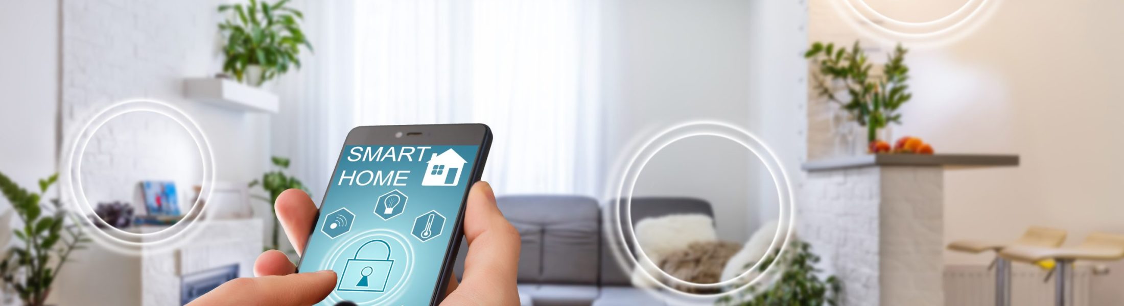 Smart home technology interface on smartphone app screen with augmented reality (AR) view of internet of things (IOT) connected objects in the apartment interior, person holding device